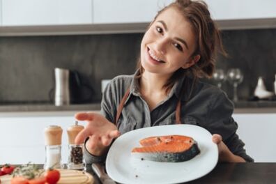 Young girl with trout steak